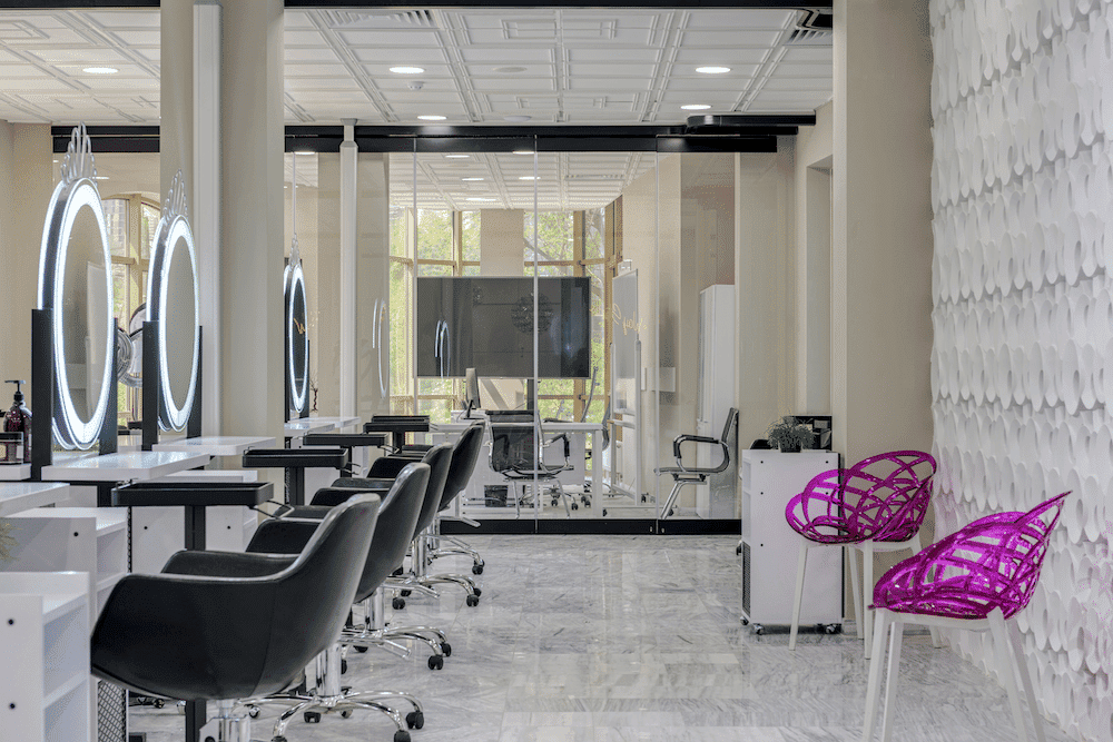 Modern hair salon interior with styling stations and mirrors.