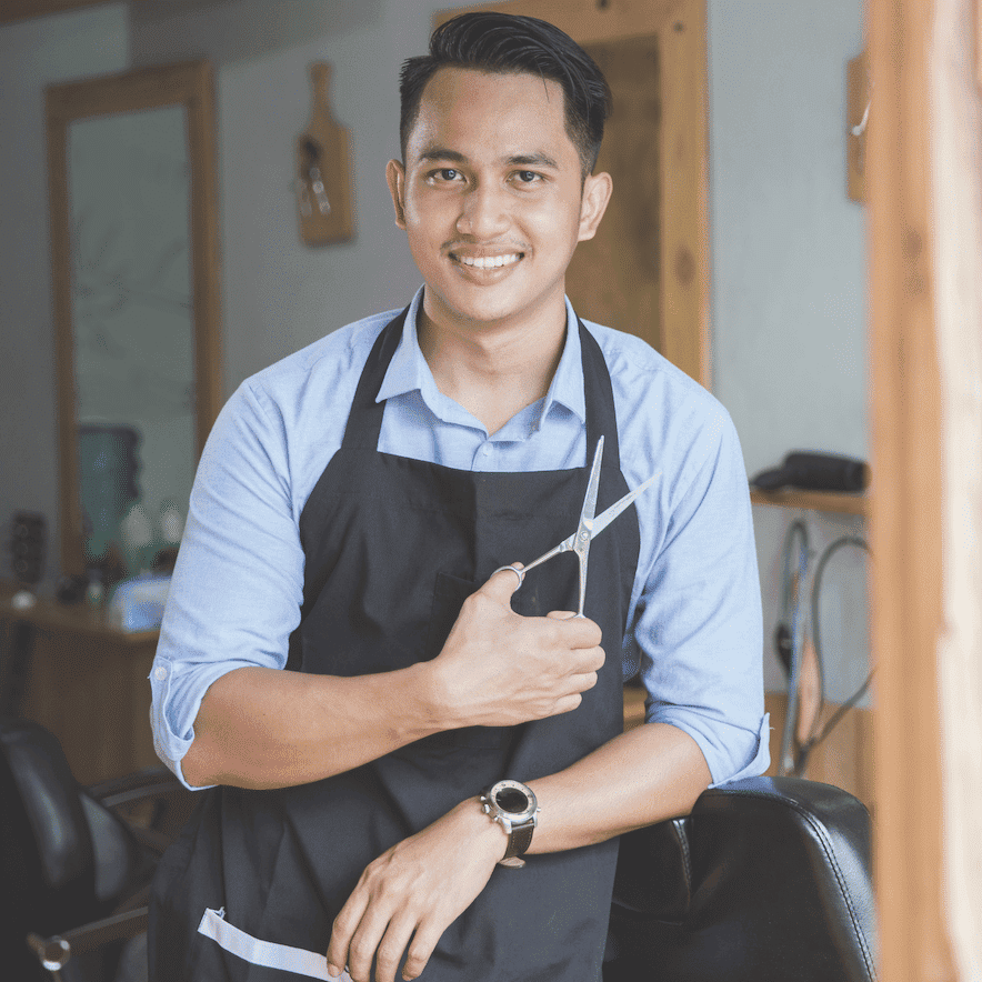 Portrait of Oscar Martinez, a professional stylist at Hibiscus Salon, showcasing their expertise and style.